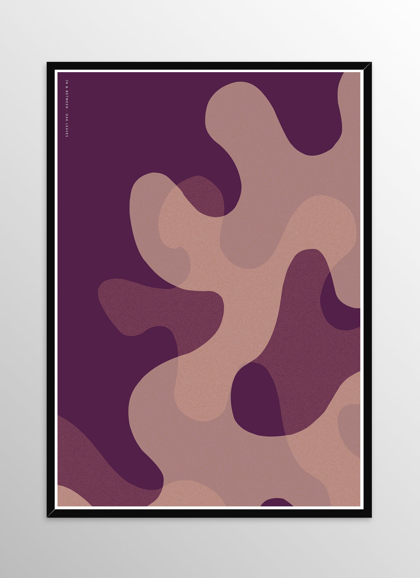 Art print of large warm violet oak leaf shapes in black wooden frame.