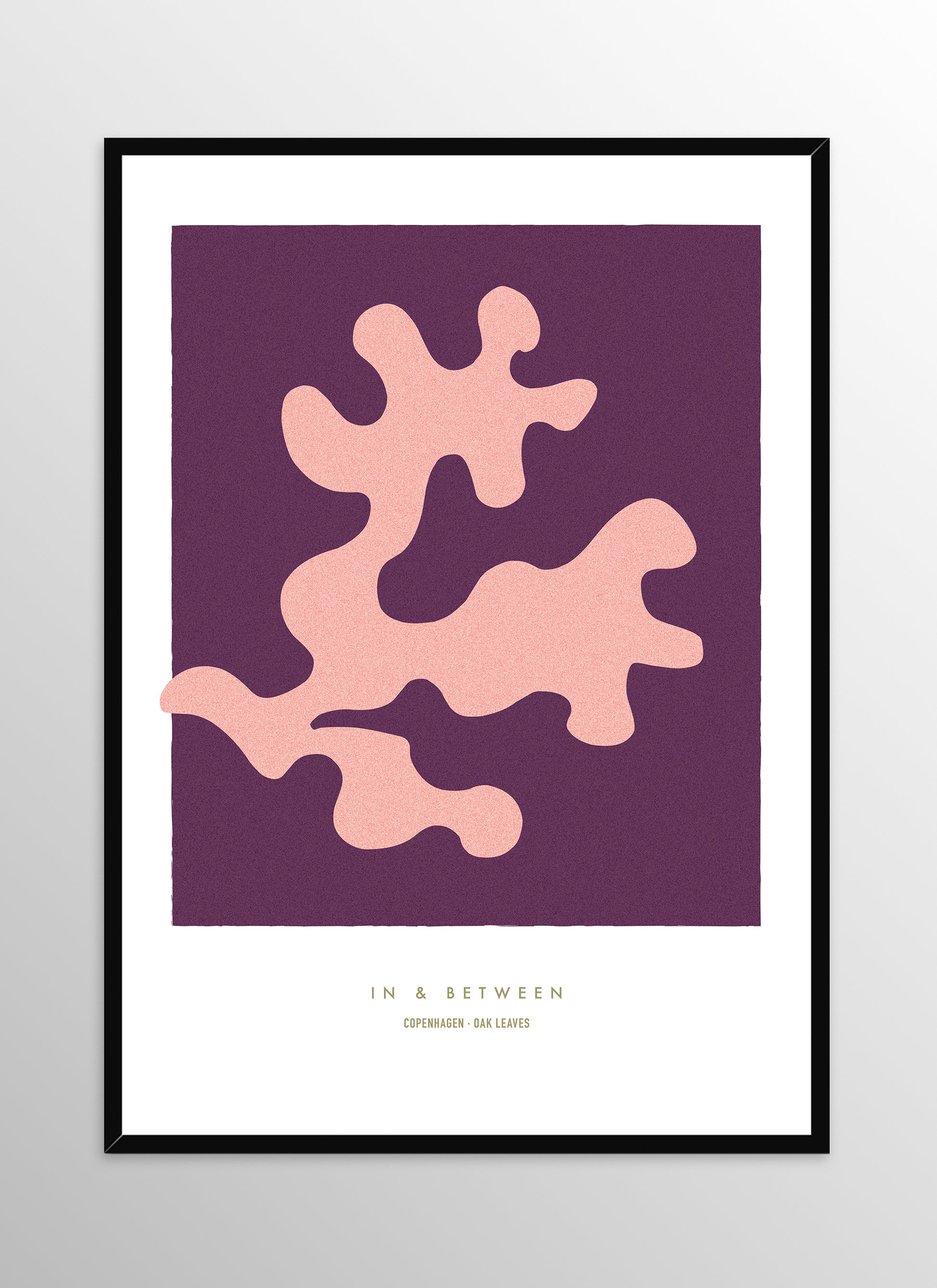 Art print of peach oak leaf on dark violet background in black wooden frame.