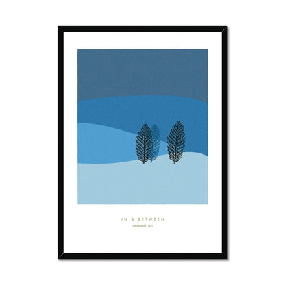Winter landscape in dark and light blue tones with two trees and black wooden frame.
